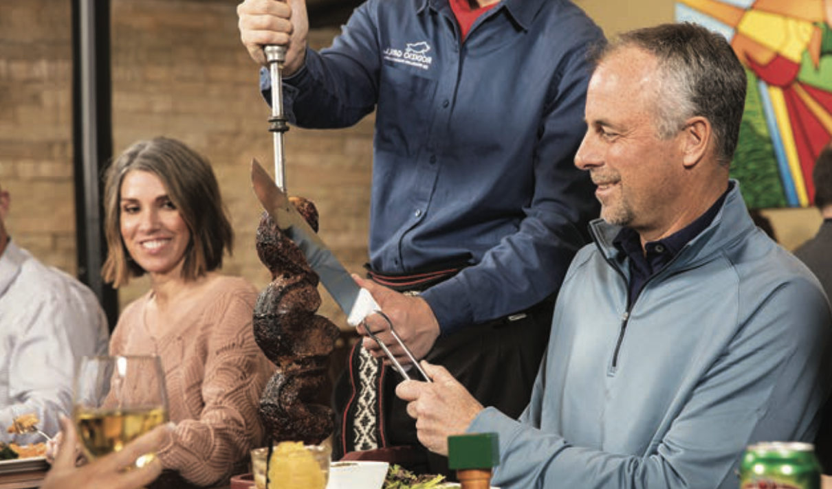 A retired couple enjoying steak at a steakhouse